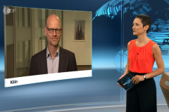 Screenshot from TV interview with moderator on the right and screen showing Niklas Höhne on the left