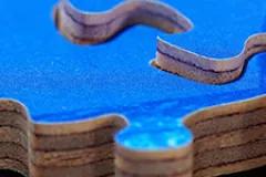 Blue puzzle pieces lying disassembled on top of each other